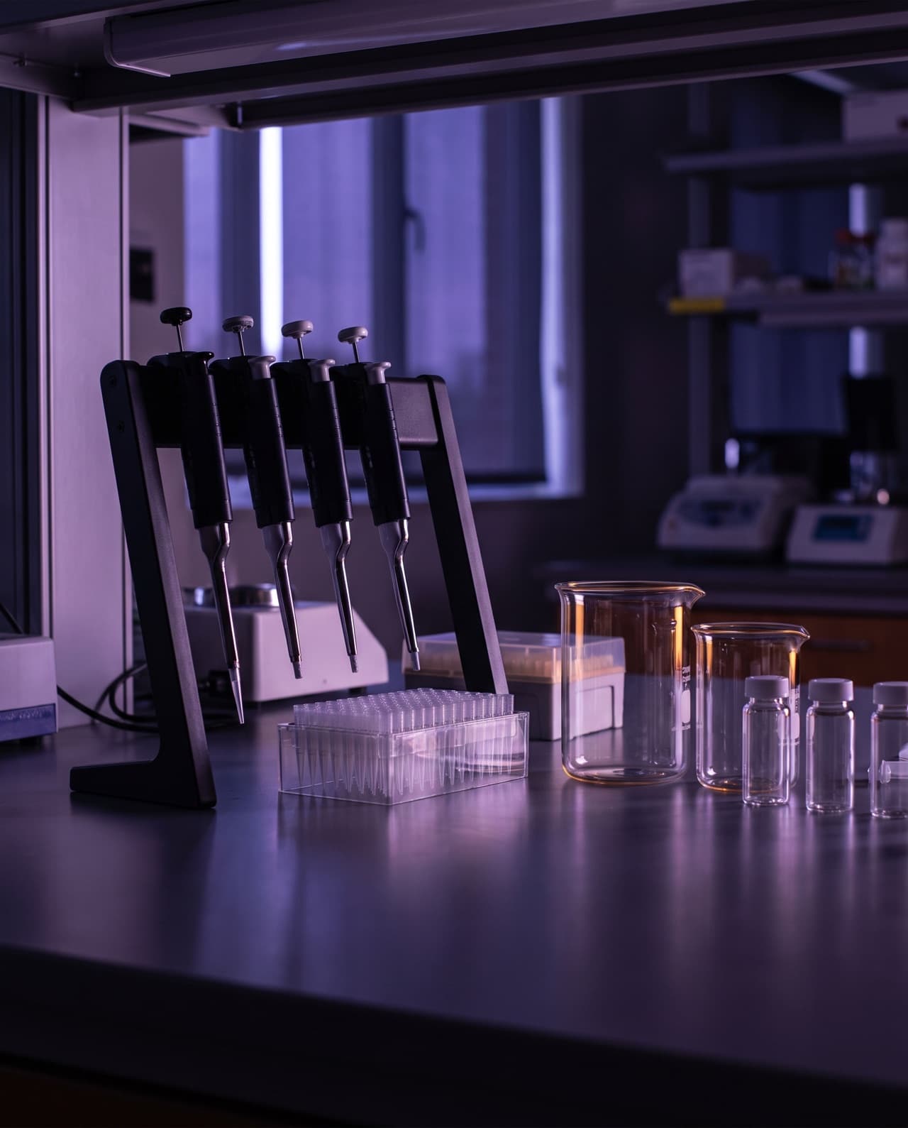 Laboratory bench illustration: micropipettes, pipette tips and glassware